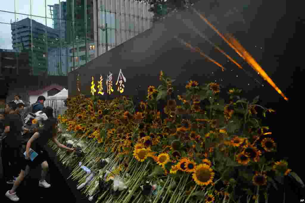 Attendees take part in a public memorial for Marco Leung, the 35-year-old man who fell to his death weeks ago after hanging a banner protesting against an extradition bill, in Hong Kong.