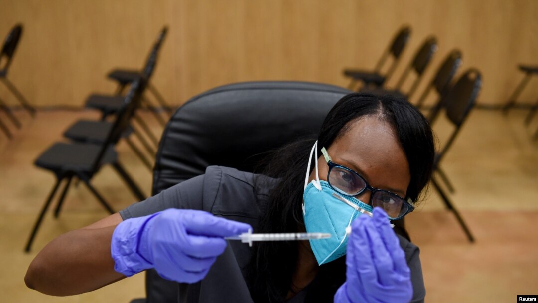 Un trabajador de la salud prepara dosis de la vacuna contra el covid, en el Acres Home Multi-Service Center, en Houston, Texas, EE. UU., el 13 octubre de 2021.