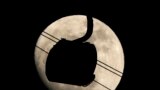 A gondola used to transport people to the biathlon and cross country skiing venues is silhouetted against the rising moon in Krasnaya Polyana, Russia.