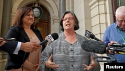 State Greens member for Western Metro Colleen Hartland and Greens member for South Eastern Metro Nina Springle give their reactions outside Parliament House during a news conference after an assisted dying vote in Melbourne, Australia, Nov. 29, 2017.