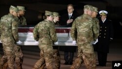 Acting Navy Secretary Thomas Modly, center, and Navy Adm. Michael Gilday, look on as an Air Force carry team moves the transfer case containing the remains of Seaman Apprentice Cameron Scott Walters, Dec. 8, 2019.