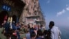 A crowd is pictured on a mountainside tourist attraction in China in the undated photo. Although China welcomes foreign trade and tourism, some foreigners say they are cautious about visiting.