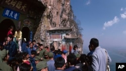 A crowd is pictured on a mountainside tourist attraction in China in the undated photo. Although China welcomes foreign trade and tourism, some foreigners say they are cautious about visiting.