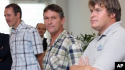 FILE - In this July 6, 2009 file photo, the released crew members of the Belgian ship 'Pompei,' Belgium's Jan Verplancke, left, James Law, right, and Dutchman Hendrik Toxopeus, address the media upon their arrival at Brussels airport.