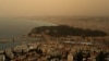 This photograph taken on March 30, 2024, shows thick sand dust blown in from the Sahara giving the sky a yellowish appearance above the French riviera city of Nice, southern France.