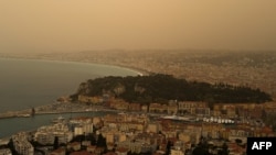 Thick sand dust blows in from the Sahara Desert on March 30, 2024, giving the sky a yellowish appearance above the French riviera city of Nice, France.