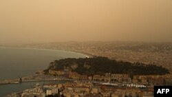 FILE—This photograph taken on March 30, 2024, shows thick sand dust blown in from the Sahara giving the sky a yellowish appearance above the French riviera city of Nice, southern France.