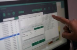 FILE - Rohitash Repswal, a digital marketer, shows a software tool that appears to automate the process of sending messages to WhatsApp users, on a screen inside his office in New Delhi, India, May 8, 2019.
