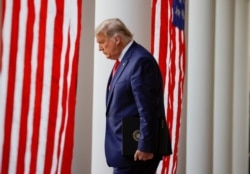 FILE - President Donald Trump walks down the West Wing colonnade from the Oval Office to the Rose Garden to speak to the press, at the White House in Washington, Nov. 13, 2020.