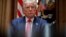 FILE - President Donald Trump listens during a meeting in the Cabinet Room of the White House, Aug. 3, 2020.
