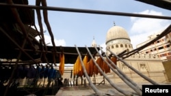 Colored yarns are hung up to dry on the roof of a dye workshop in old Cairo, Egypt, March 17, 2016. 