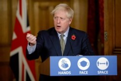 Britain's Prime Minister Boris Johnson speaks during a virtual press conference on the coronavirus pandemic at 10 Downing Street in London, Nov. 9, 2020.