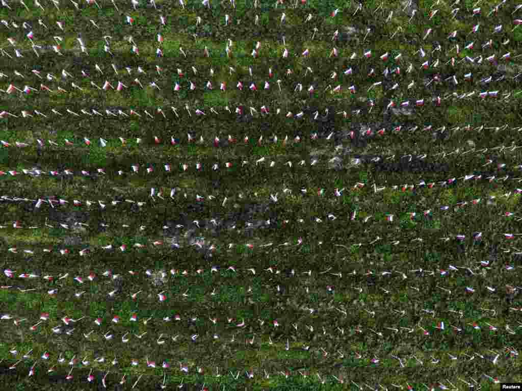 An aerial view shows flags planted by protesters in tribute to those who have died of COVID-19, in Ljubljana, Slovenia.