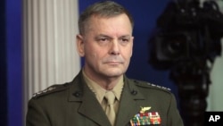 In this Dec. 16, 2010, photo, Vice Chairman of the Joint Chiefs of Staff Marine Gen. James Cartwright listens as President Barack Obama speaks about the Afghanistan-Pakistan Annual Review at the White House in Washington.