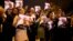 In this photo released by the Iranian Students News Agency, ISNA, Iranians hold posters of President Hassan Rouhani as they welcome Iranian nuclear negotiators upon their arrival from Geneva at the Mehrabad airport in Tehran, Nov. 24, 2013. 