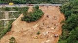 This aerial drone photo taken on May 2, 2024, shows rescuers and excavators working at the site of a highway section that collapsed on the Meizhou-Dabu Expressway in Meizhou, China. (Xinhua News Agency via AP)