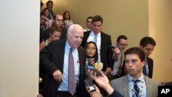 Senator John McCain dari Arizona dikejar para wartawan setelah menolak undang-undang yang diusulkan untuk mencabut Obamacare.