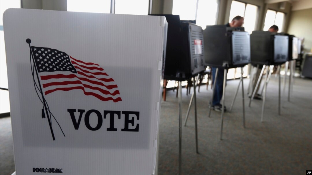 FILE - Voters cast ballots in Hinsdale, Ill., March 18, 2014. 