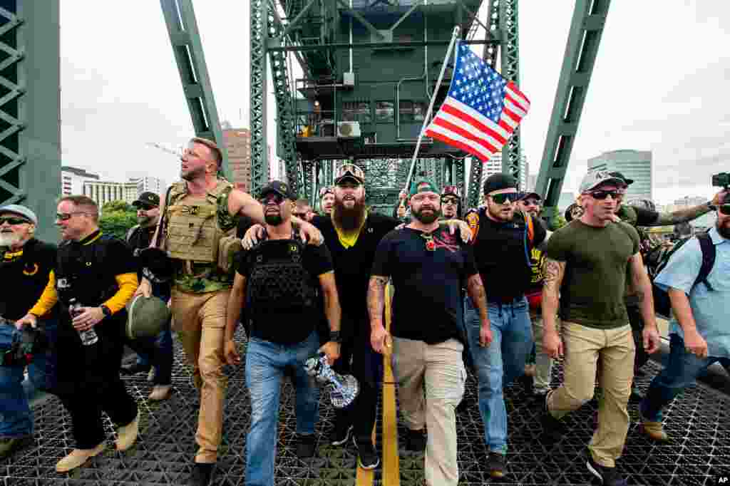 Members of the Proud Boys and other right-wing demonstrators march across the Hawthorne Bridge during an "End Domestic Terrorism" rally in Portland, Oregon, USA, Aug. 17, 2019.