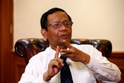 FILE - Indonesian Chief Security Minister Mohammad Mahfud MD gestures as he talks during an interview at his office in Jakarta, Indonesia, Dec. 26, 2019.