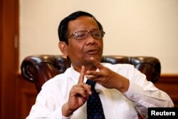 FILE - Indonesian Chief Security Minister Mohammad Mahfud MD gestures as he talks during an interview at his office in Jakarta, Indonesia, Dec. 26, 2019.