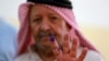 A Jordanian man displays his ink-stained finger after casting his vote in parliamentary elections at a polling station in al-Salt near the capital Amman on Sept. 10, 2024. 