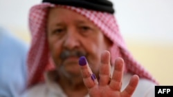 A Jordanian man displays his ink-stained finger after casting his vote in parliamentary elections at a polling station in al-Salt near the capital Amman on Sept. 10, 2024. 