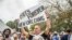 FILE - Fans parade down Poland Avenue toward the former home of music legend Antoine 'Fats' Domino during a second line parade honoring him on Nov. 1, 2017 in New Orleans.