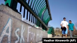 Cornell University students cross the college's Thurston Avenue Bridge in Ithaca, NY.