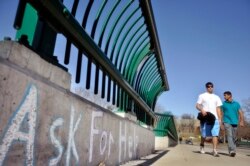 Cornell University students cross the college's Thurston Avenue Bridge in Ithaca, NY.