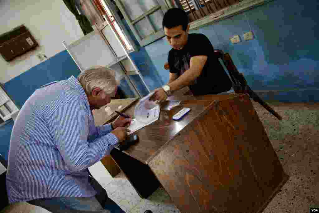 Retired pharmacist Makhmoud Mokhtar, left, cast his vote for Ahmed Shafiq, Cairo, Egypt, June 16, 2012. (Y. Weeks/VOA)