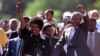 Nelson Mandela and his then wife, Winnie, salute well-wishers as he leaves Victor Verster prison on February 11, 1990. 