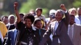Nelson Mandela and his then wife, Winnie, salute well-wishers as he leaves Victor Verster prison on February 11, 1990. 