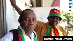 Cameroon fans Moise Kamgan and Nylot Tapet watched their team play in Brasilia, Brazil, June 21, 2014. (Nicolas Pinault/VOA)