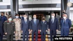 Turkish Foreign Minister Mevlut Cavusoglu poses with Libyan Foreign Minister Najla el-Mangoush in Tripoli, Libya, May 3, 2021.