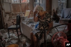 Margarita Salazar, 82, wipes the sweat off with a tissue inside her home amid hot weather in Veracruz, Mexico, June 16, 2024.