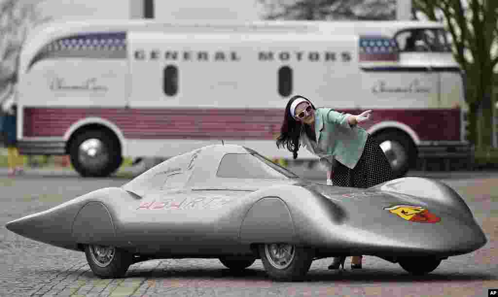 Natasha poses for photographers with a vintage Fiat-Abarth 1000 Pininfarina to promote the vintage car show &#39;Techno Classica&#39; in Essen, Germany.