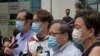 Beberapa terdakwa termasuk aktivis pro-demokrasi, dari kiri, Richard Tsoi, Figo Chan dan Albert Ho saat memberikan keterangan kepada media di luar pengadilan di Hong Kong, Senin, 17 Mei 2021. 