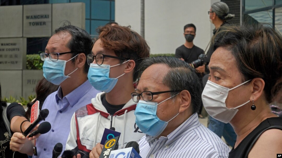 Various defendants including pro-democracy activists, from left, Richard Tsoi, Figo Chan and Albert Ho speak to media outside a court in Hong Kong, May 17, 2021.