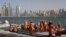 FILE - Laborers work at a construction site at the Palm Jumeirah, in Dubai, United Arab Emirates.