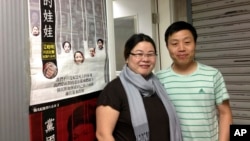 Beijing-based video and photojournalist Du Bin, right, poses for photos with Chinese activist Ye Haiyan outside the venue in Hong Kong where Du Bin first publicly screened his documentary, May 1, 2013. 