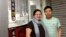 Beijing-based video and photojournalist Du Bin, right, poses for photos with Chinese activist Ye Haiyan outside the venue in Hong Kong where Du Bin first publicly screened his documentary, May 1, 2013. 