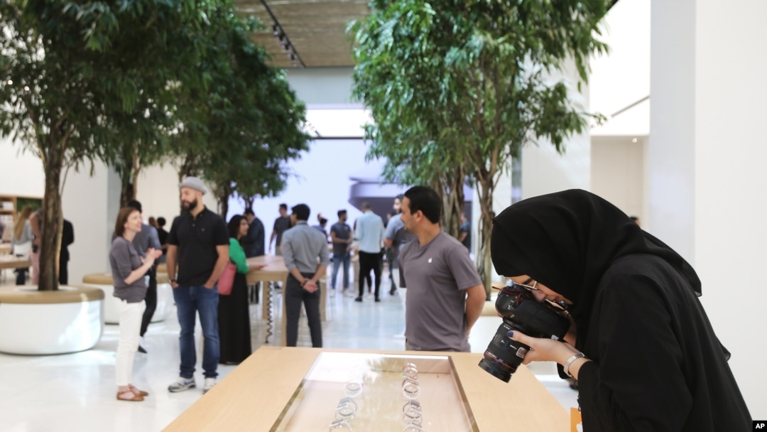 A photographer takes a photo of apple watches at the Apple Store ahead of their grand opening in Dubai, United Arab Emirates, Oct. 27, 2015.