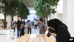 A photographer takes a photo of apple watches at the Apple Store ahead of their grand opening in Dubai, United Arab Emirates, Oct. 27, 2015.