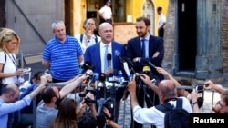 Journalists Emiliano Fittipaldi (R) and Gianluigi Nuzzi talk to reporters as they leave the Vatican at the end of their trial, in Rome, Italy, July 7, 2016. 