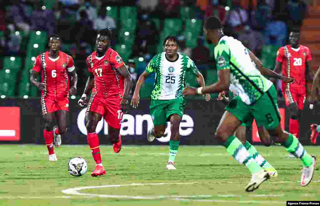 Guinea-Bissau's midfielder Mama Balde (2L) fights for the ball with Nigeria's midfielder Kelechi Nwakali (C) during the football match between Guinea-Bissau and Nigeria in Cameroon on Jan. 19, 2022.