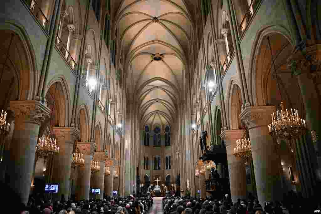 People attend the traditional Christmas mass in the Notre-Dame de Paris cathedral in Paris, Dec. 24, 2024, for the first time since the fire in 2019.