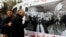 A man cries next to a poster with an image of Chokri Belaid, a prominent Tunisian opposition politician who was shot dead, Tunis February 7, 2013.