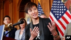 FILE - Hong Kong activist Denise Ho, center, speaks as she is joined by members of Congress during a news conference on human rights in Hong Kong on Capitol Hill in Washington, Sept. 18, 2019.