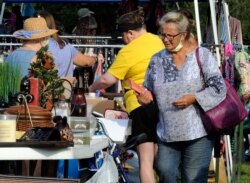 A crowd looks through items at the World's Longest Yard Sale, which stretches from Alabama to Michigan, at its southernmost point in Gadsden, Ala., on Aug. 6, 2020.